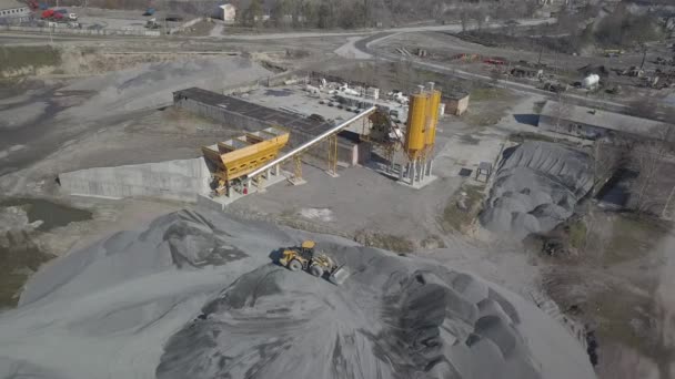 Producción de piedra triturada y materiales de construcción a granel. Vista de la cantera desde una altura. Fotografía aérea de un dron o cuadrohelicóptero. Panorama de los trabajos de construcción con el uso de equipos pesados — Vídeos de Stock