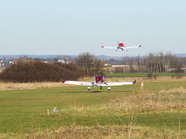 Çimen havaalanının pistinden aynı anda iki turbopervane uçağı kalkıyor. Hava gösterisinde boş zaman. Seyahat ve eğlence için özel havacılık. Havacılık endüstrisinin teknolojisi..