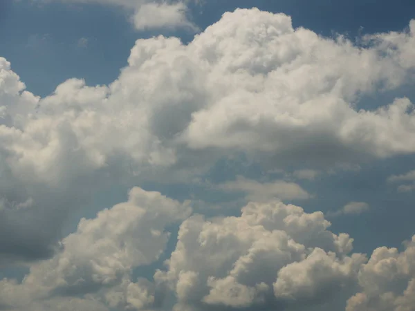 Clear blue sky with cumulus and cirrus clouds. Sunny weather. Joyful mood. High pressure. Clean air ecology. Water in a gaseous state. The source of rain and hail. Weather prediction.