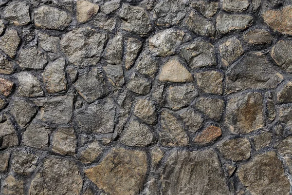 Close up van versleten granieten rots stenen muur — Stockfoto