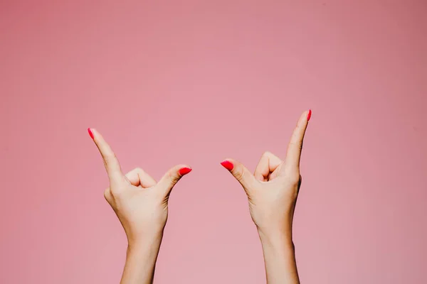 Kvinnans Händer Med Ljusa Manikyr Isolerad Rosa Bakgrund Pekfingrar Upp — Stockfoto