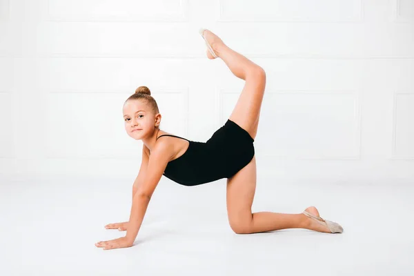 Young Girl Doing Gymnastic Exercise Raising One Leg White Background — Stock Photo, Image