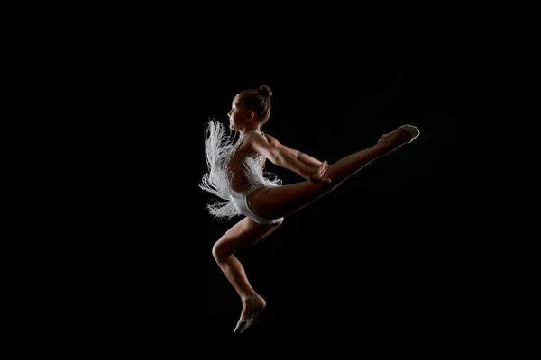 Kleine Gymnast Een Witte Sprankelende Jurk Een Zwarte Achtergrond Springen — Stockfoto