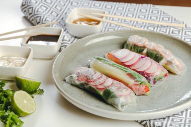 Bir tabakta servis edilen karides ve soslu nefis börekler. yatay görünüm.