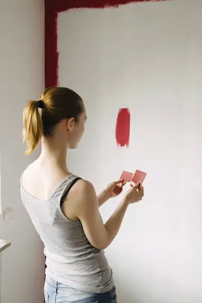 Rear View Woman Comparing Color Swatches Wall — Stock Photo, Image