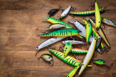 Artificial lure. Wobblers on wooden background clipart