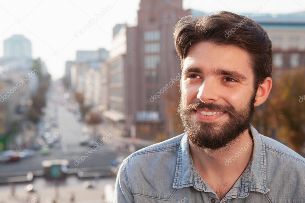 Handsome bearded man enjoying warm day at the city