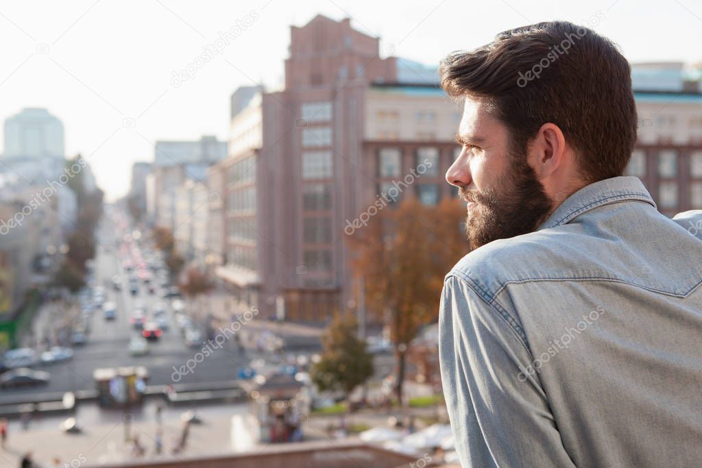 Handsome bearded man enjoying warm day at the city