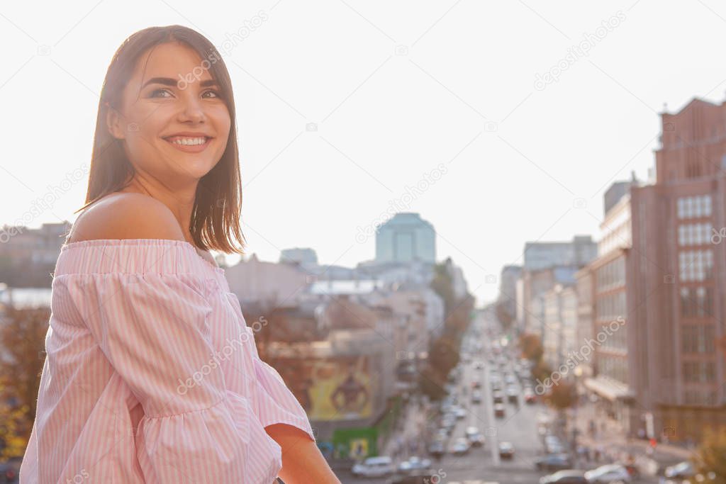 Happy beautiful woman on city streets