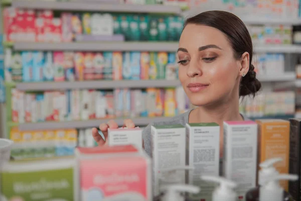 Charming woman shopping at pharmacy — Stock Photo, Image