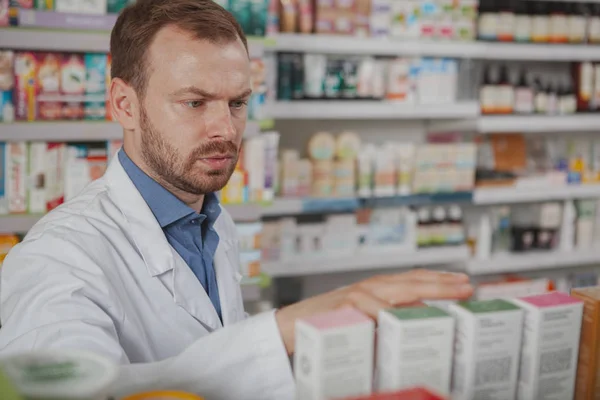 Cheerful mature male pharmacist at the drugstore — Stock Photo, Image