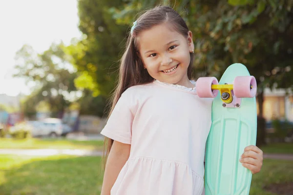 Lovely little Asian girl at the park on a summer day — Stock Photo, Image