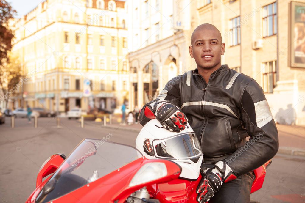 African man on a sport motorbike in the city