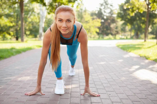 Gorgeous athletic woman working out in the park in the morning Stock Picture