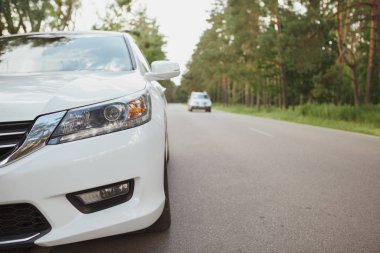 Otoyolun kenarındaki beyaz araba.