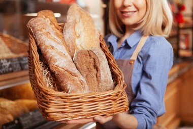 Bir sepet dolusu taze pişmiş ekmeği neşe dolu fırıncının ellerinde yakından çek.
