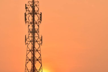Kablosuz iletişim anteni ile parlak gökyüzü. Turuncu gökyüzü antenler ile telekomünikasyon Kulesi.