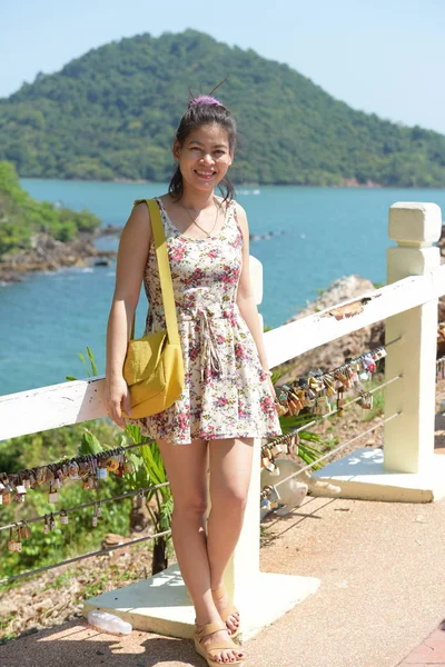 Asian woman posing near sea coast