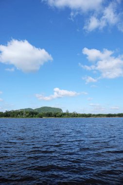 Lake görünümü orada güzel bulutlu bir gökyüzü ise yeşil dağların ağaçları ile.