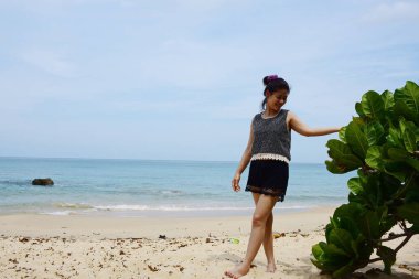 Güzel bir plaj, beyaz dalgalar, kayalar ve balıkçı tekneleri, esinti, güneş parlak gün ışığında beyaz kum plaj.