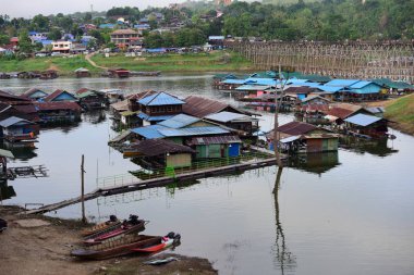 Turistler ve nehir görünümünü ve çevresindeki topluluklar barajın Pzt Bridge Khao Laem Barajı, Sangklaburi, Thailand.2018, 5 Mayıs oteller