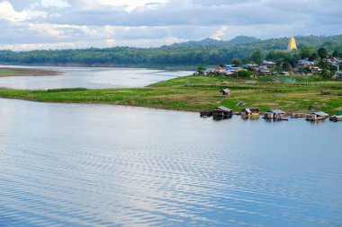 Gündoğumu veya günbatımı dağ, sabahın erken saatlerinde. Altın, güzel ve renkli gökyüzüdür. Sahne bir altın sarı gökyüzü güzel bulutlar, su barajlar ve tekneler, köylüler ve toplum konut vardır.