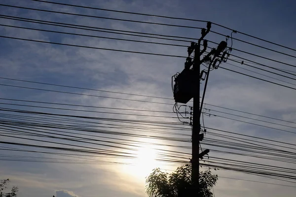 High-voltage transmission towers Send electricity from the power plant to the people. With the golden sky in the sunset