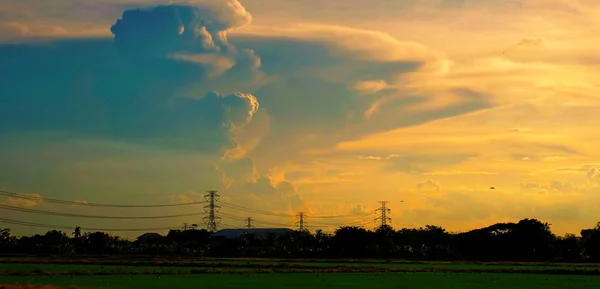 High-voltage transmission towers Send electricity from the power plant to the people. With the golden sky in the sunset