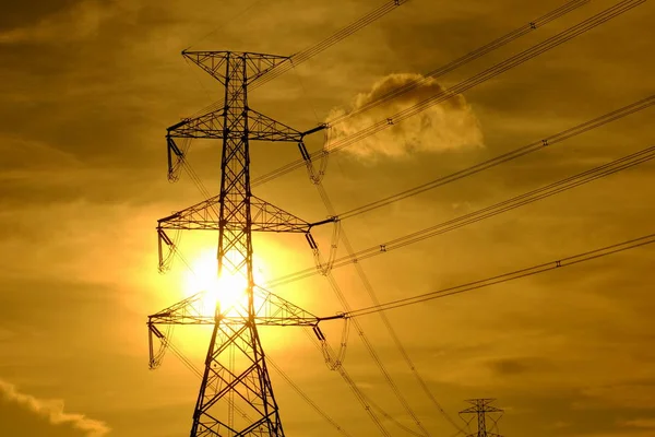 High-voltage transmission towers Send electricity from the power plant to the people. With the golden sky in the sunset