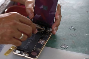 Akıllı telefonu tamir eden adama yaklaş.  
