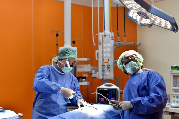 Medical Team Performing Surgical Operation in Modern Operating Room. Equipment and medical devices in hybrid operating room.scrub nurse preparing medical instruments for operation.