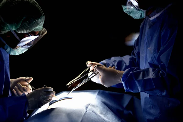 Medical Team Performing Surgical Operation in Modern Operating Room. Equipment and medical devices in hybrid operating room.scrub nurse preparing medical instruments for operation.