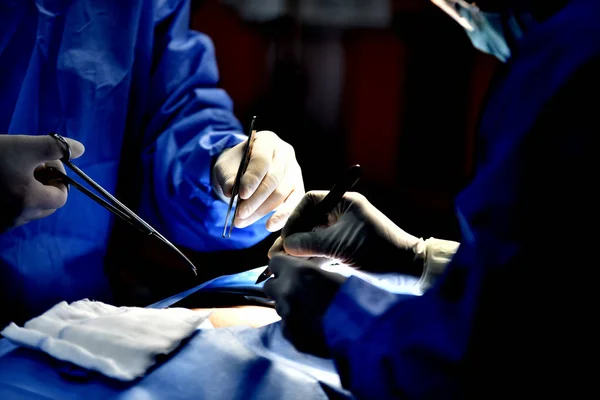 Medical Team Performing Surgical Operation in Modern Operating Room. Equipment and medical devices in hybrid operating room.scrub nurse preparing medical instruments for operation.