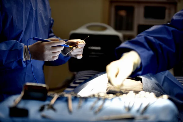 Medical Team Performing Surgical Operation in Modern Operating Room. Equipment and medical devices in hybrid operating room.scrub nurse preparing medical instruments for operation.