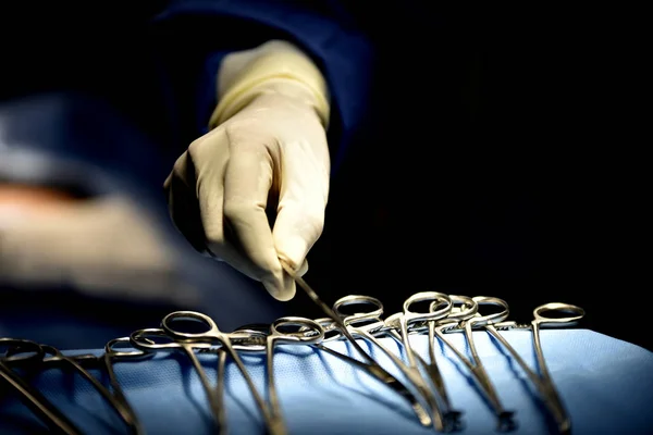 Medical Team Performing Surgical Operation in Modern Operating Room. Equipment and medical devices in hybrid operating room.scrub nurse preparing medical instruments for operation.