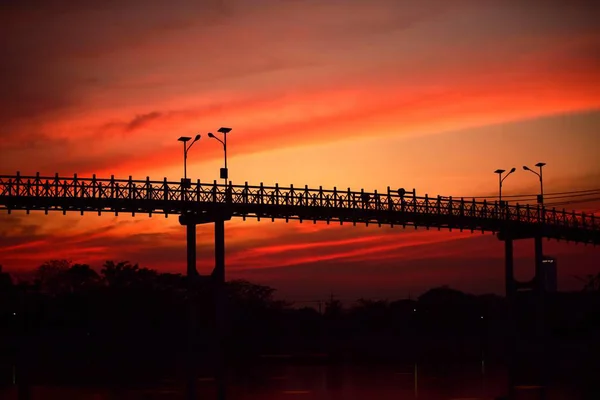日落时在桥上行走的人 — 图库照片