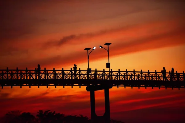 Menschen Gehen Bei Sonnenuntergang Auf Brücke — Stockfoto