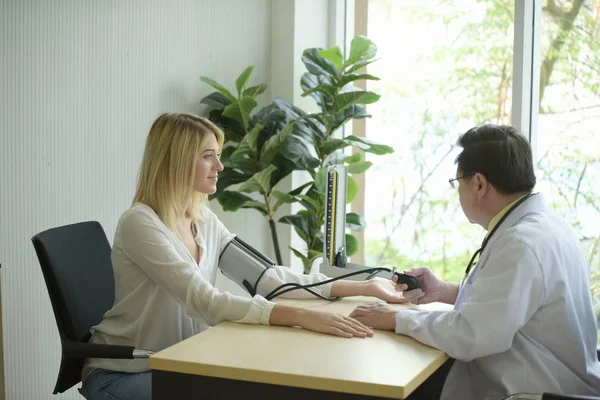 Beautiful girl consulted the doctor,Woman talking to doctor psychiatrist in hospital,Discuss issue and find solutions to mental health problems.