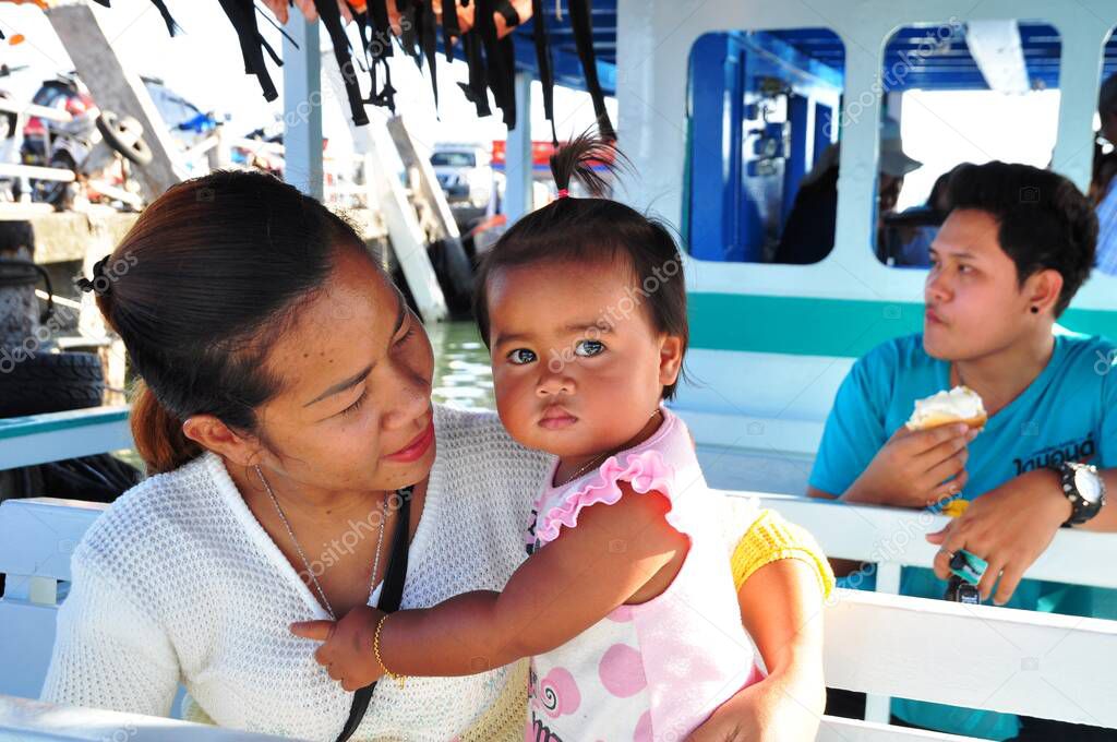 Asian woman with daughter on boat