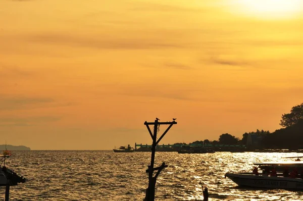 Sunrise view at the sea,The rising sun view and the beach. Beautiful golden yellow sky and sun The view of the beach,