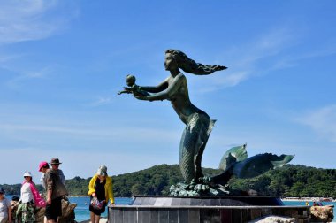 22 April, 2002 - Thailand: Sculpture of mermaid with child on sea coast