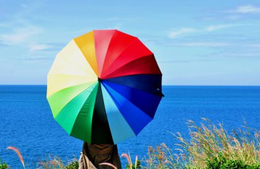 Koh Samet 'in sahil şeridine bakan tepede renkli şemsiyeli güzel kadınlar..