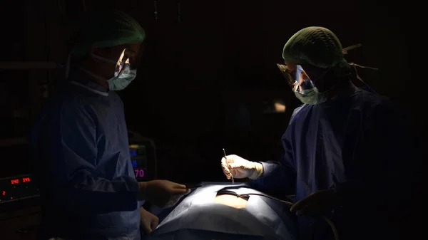 surgeon in operating room with art lighting