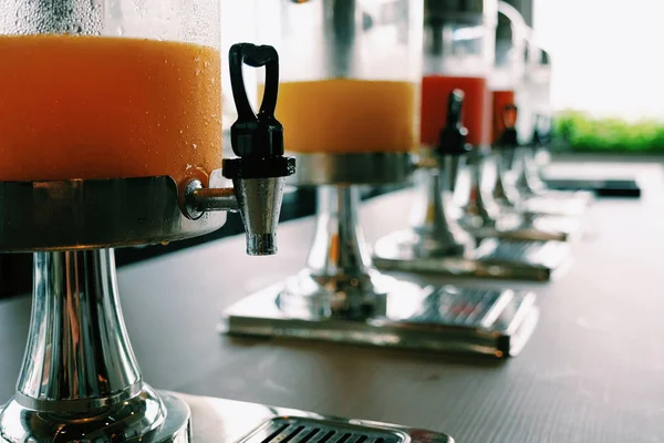 selective focus at heart valve shape of juice dispenser on the table. / concept of refreshment and healthy