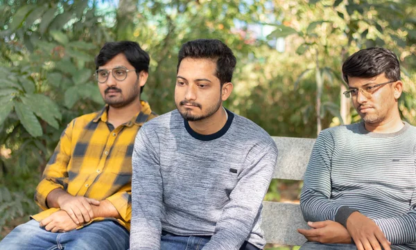 Трое бородатых друзей на столе в парке - о бородке, отсутствии общения и драке между друзьями — стоковое фото