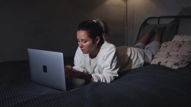 Portret Van Meisje Ligt Bed Haar Buik Typt Laptop Toetsenbord — Stockvideo