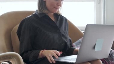 Yan Çekim: Ofiste ya da evde bilgisayarla çalışan, müşterilerle iletişim kuran konsantre genç iş kadını. Odaklanmış başarılı uluslararası kadın şirket çalışanı proje ile meşgul.