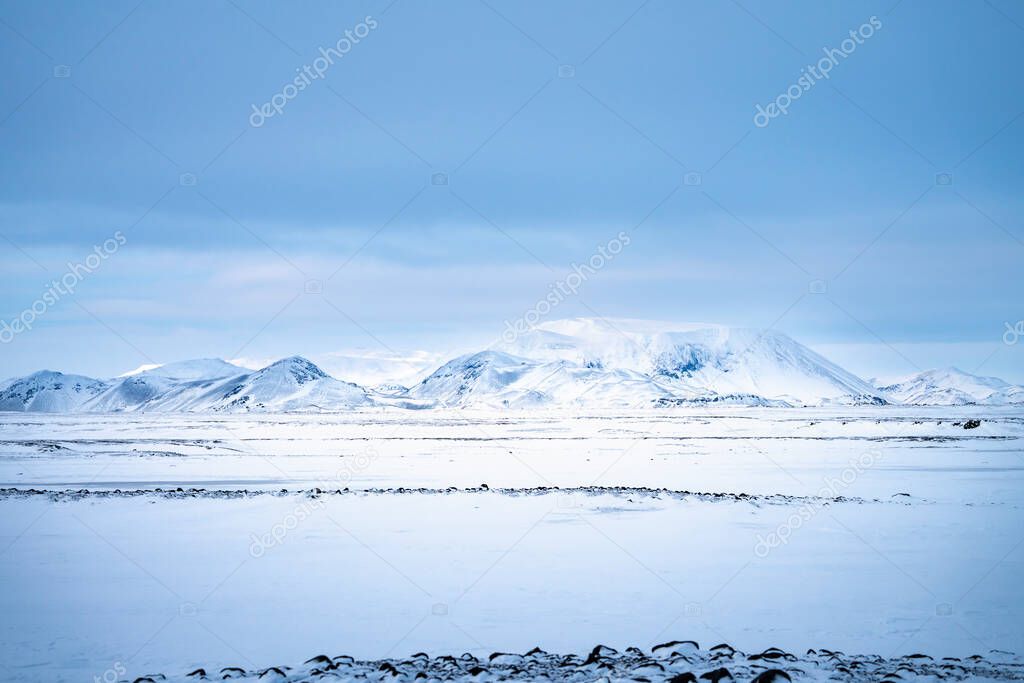 Snow covered mountains and Icelandic volcanic landscape in winter near Lake Myvatn, north east Iceland