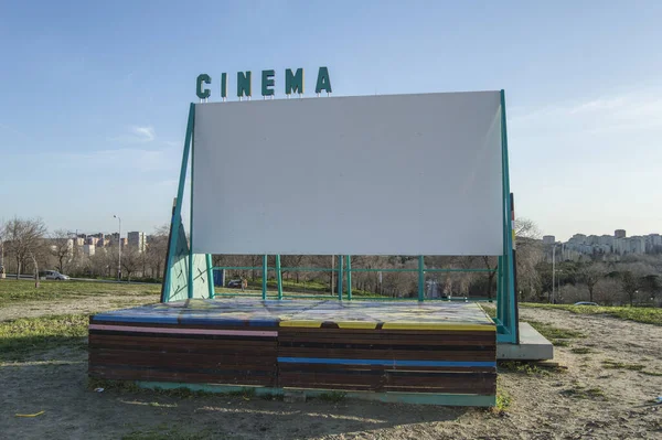 a small outdoor movie screen in an outdoor park