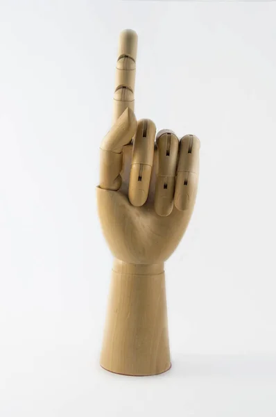 articulated wooden hand with index finger raised pointing up